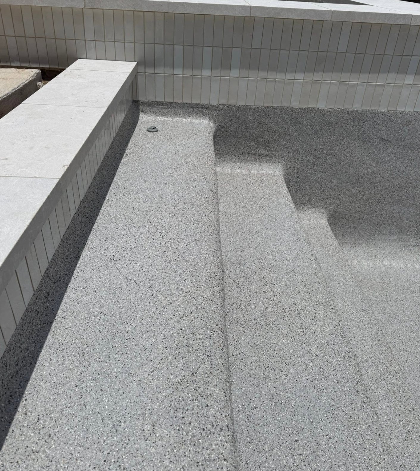 French Grey pebble pool finish before filling with water