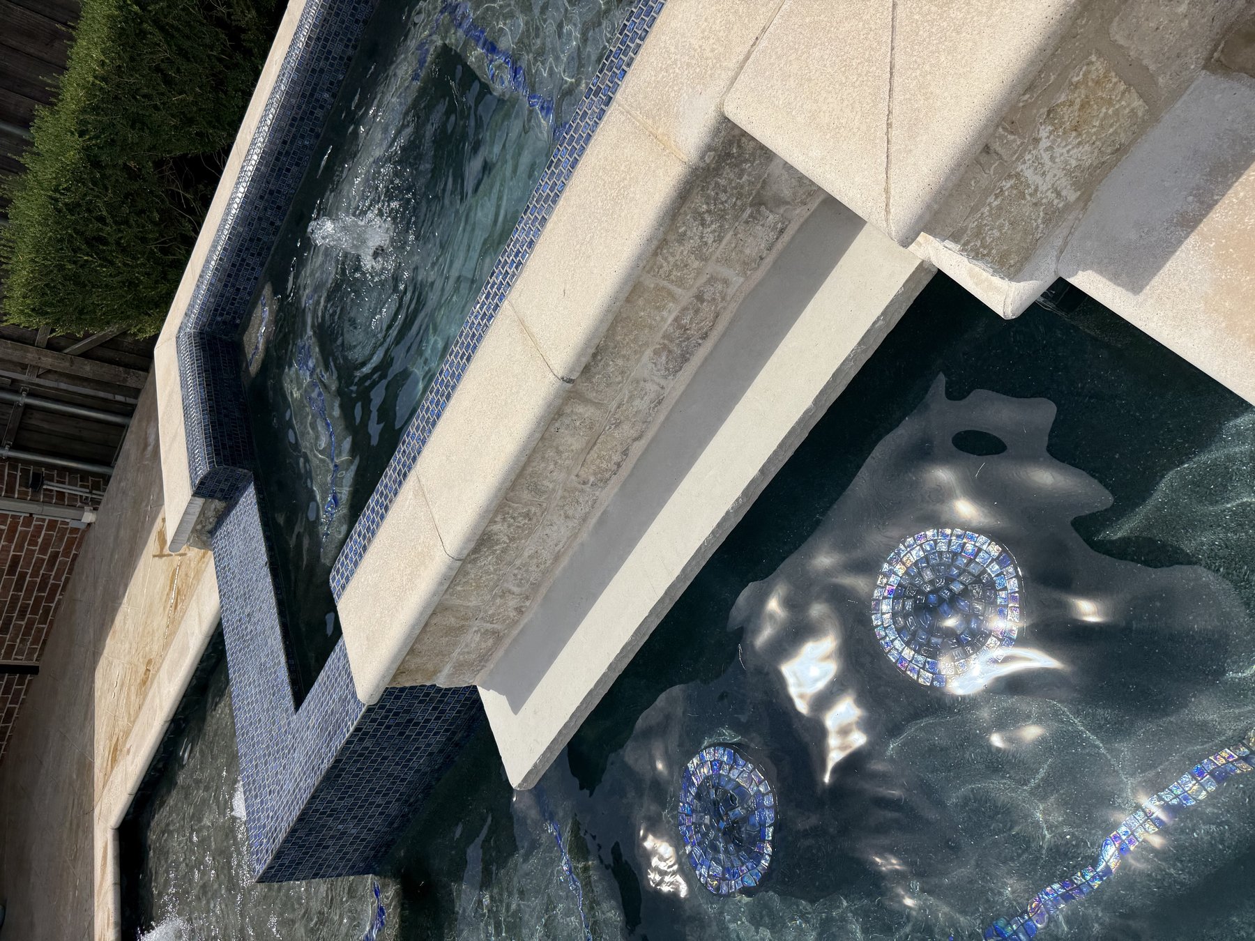 Remodeled raised spa with new glass tile and bubbler water feature, North Texas